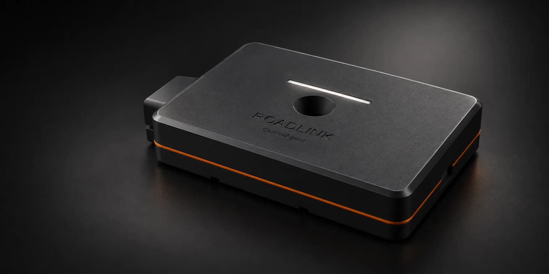 Roadlink Rev A2 product concept: a matte charcoal slab with an orange gasket seam, a thin white light line, a recessed circular touch well and a single cable hood.